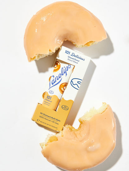 Flat lay of Lanolips 101 Ointment Multi-Balm in Glazed Donut, pictured with a bitten donut. If you love 101 Fruities, you will love 101 Delicious. Our new Lanolips 101 Delicious range comes in two all-natural flavours: Glazed Donut and Raspberry Shortcake.