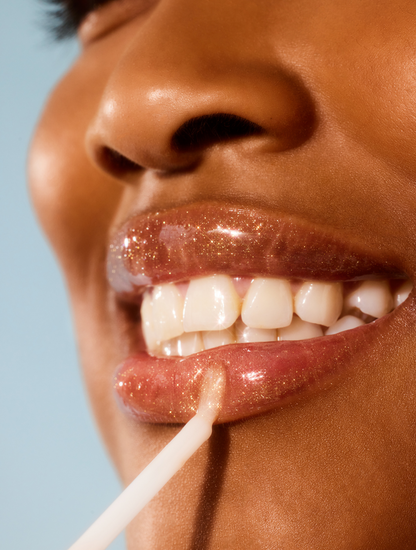 Model applying Lanolips Lip Water Liquid Gold