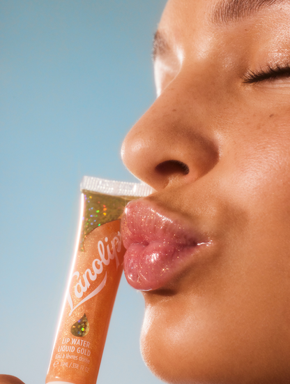 Model wearing Lanolips Lip Water Liquid Gold